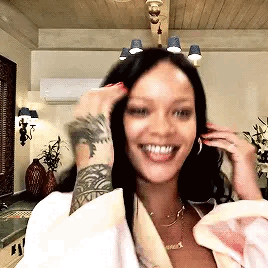 Woman With Arm Tattoo Smiling Touching Hair GIF