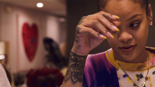 Woman With Arm Tattoo Wiping Eyes GIF