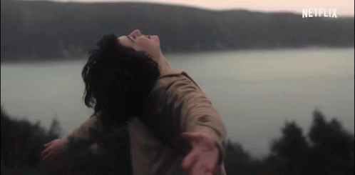 Woman With Arms Outstretched Near Water GIF