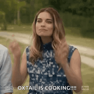 Woman with Arms Up Saying Oxtail Is Cooking