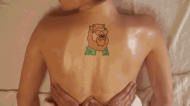 Woman With Back Tattoo Having Sensual Massage GIF