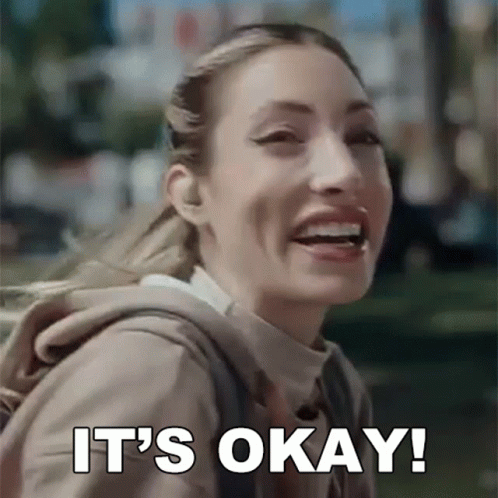 Woman With Backpack Smiling And Saying It's Okay GIF