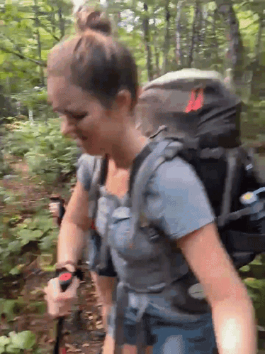 Woman With Backpack Walking Through Forest GIF