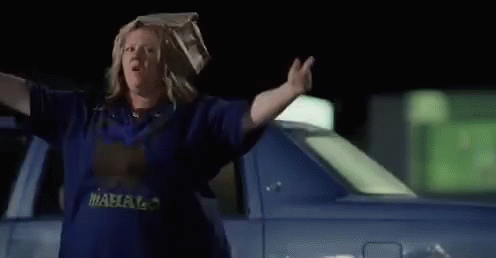 Woman With Bag On Head Walking At Night GIF