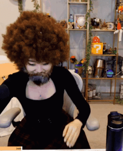 Woman with Big Afro and Beard at Microphone