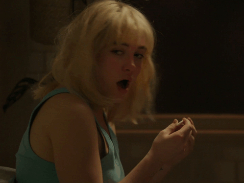 Woman With Blonde Hair and Blue Tank Top Surprised