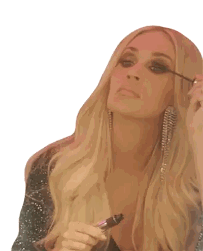 Woman with Blonde Hair Applying Mascara