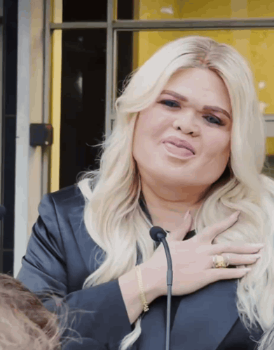 Woman With Blonde Hair Holding Chest GIF