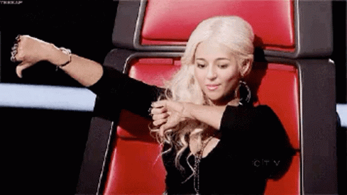 Woman With Blonde Hair Sitting In Red Chair GIF