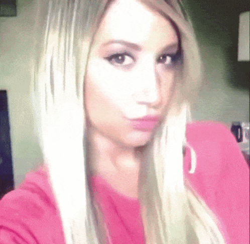 Woman With Blonde Hair Taking Selfie GIF
