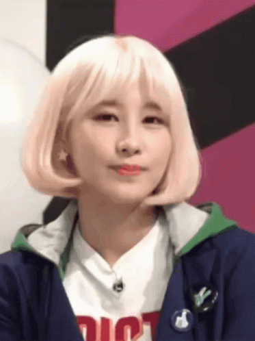 Woman With Blonde Hair Wearing Dior Shirt And Blue Jacket GIF