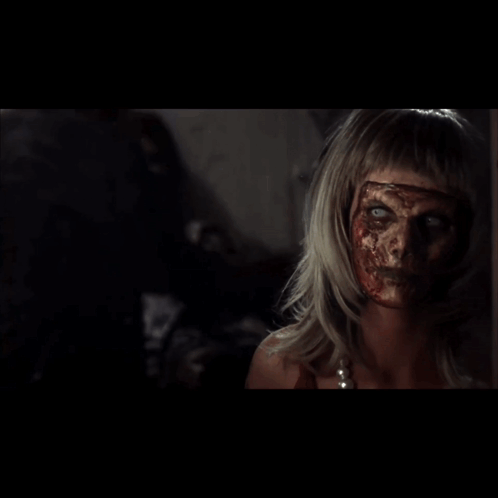 Woman With Blood On Face Looking In Mirror GIF