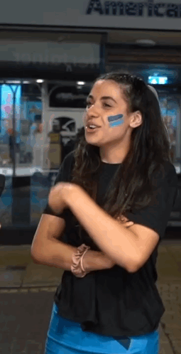 Woman with Blue Face Paint in Front of American Airlines