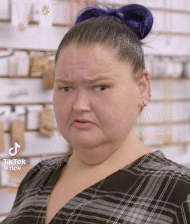 Woman With Blue Hair Bun Making Funny Face GIF