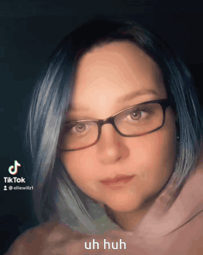 Woman With Blue Hair Glasses and Pink Hoodie
