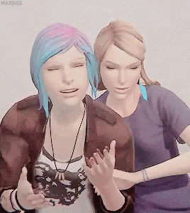 Woman With Blue Hair Hugging Blonde Woman