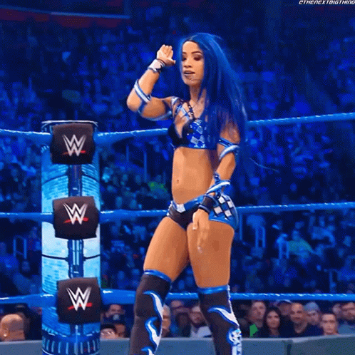 Woman with Blue Hair in Wrestling Ring with W on Back