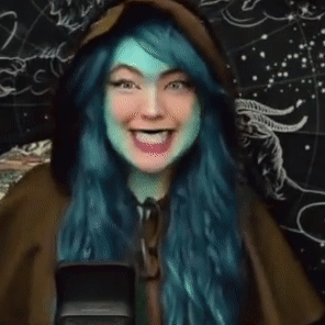 Woman with Blue Hair Laughing at Microphone