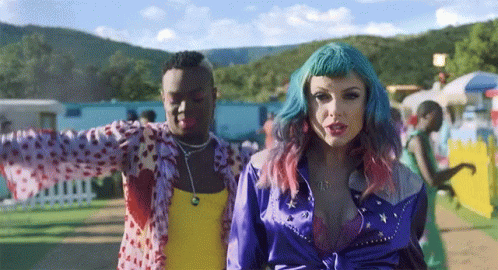 Woman with Blue Hair Next to Man in Yellow Tank Top