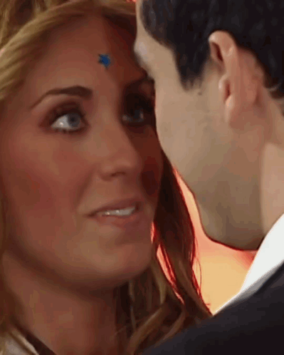 Woman With Blue Star On Forehead Kisses Man GIF