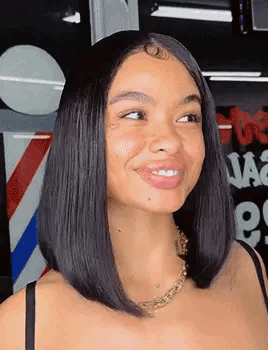 Woman with Bob Hairstyle Smiling at Barber Pole