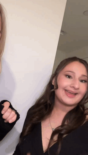 Woman With Braces Smiling Beside Another GIF