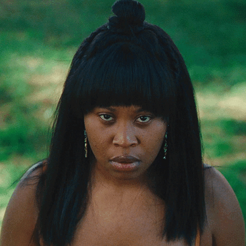 Woman With Braided Hair And Earrings Serious Look GIF