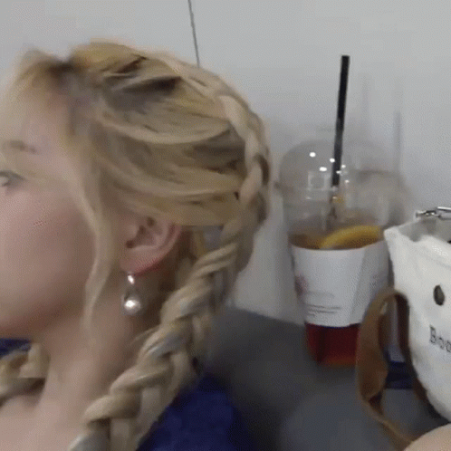 Woman With Braided Hairstyle And Earrings GIF