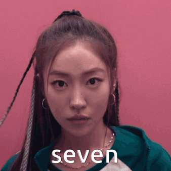 Woman With Braids And Seven On Face GIF
