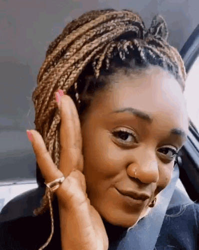 Woman with Braids Sitting in Car