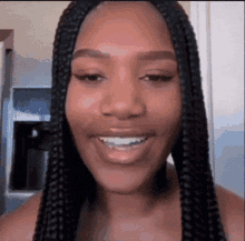 Woman with Braids Smiling in Kitchen