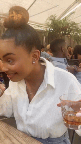 Woman With Bun Holding Whiskey Glass GIF