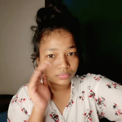 Woman With Bun In White Floral Shirt GIF