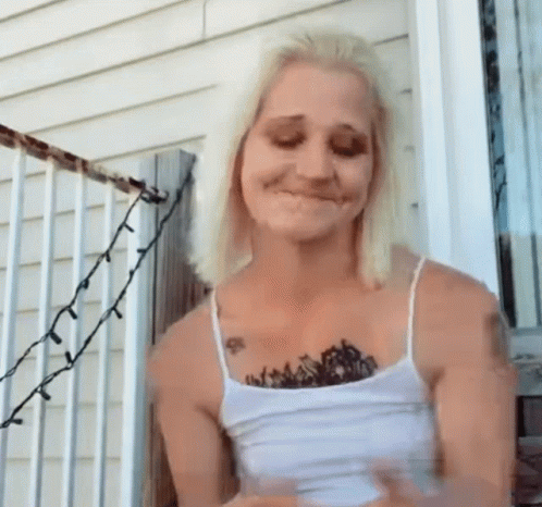Woman With Chest Tattoo Standing on Porch