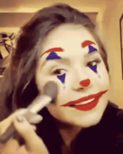Woman With Clown Face Paint Applying Makeup