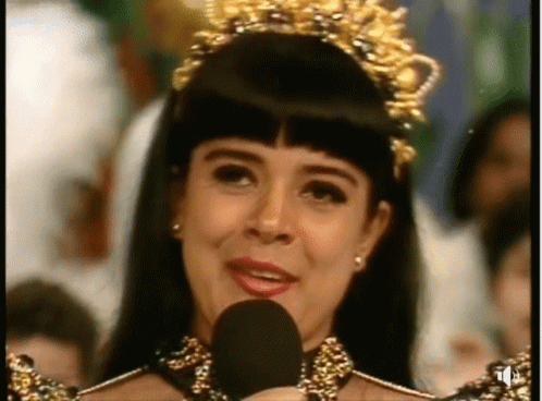 Woman With Crown Speaking Into Microphone