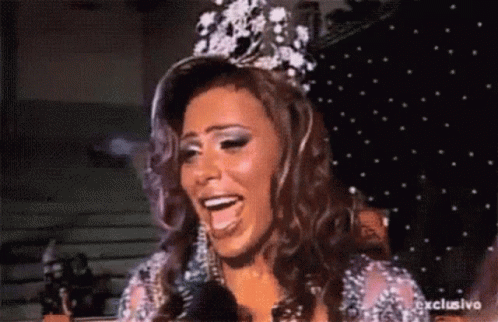 Woman With Crown Talking Into Microphone