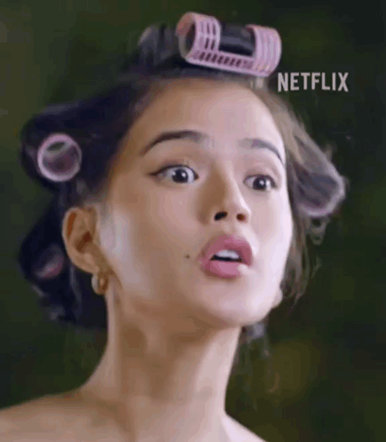Woman With Curlers Making Funny Face GIF
