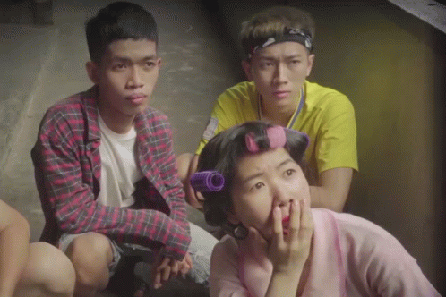 Woman With Curlers Sitting With Two Men