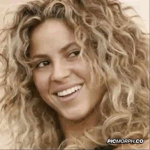 Woman With Curly Blonde Hair Smiling GIF