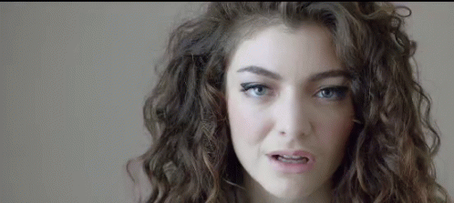 Woman With Curly Hair And Blue Eyes Making Funny Face GIF