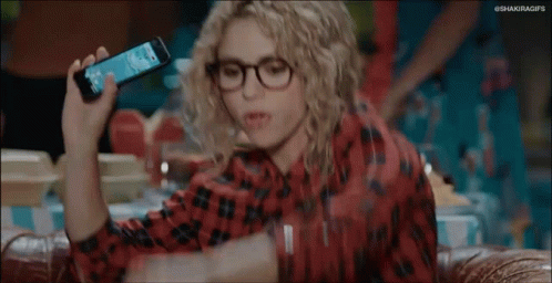 Woman With Curly Hair and Glasses Arms Up on Couch