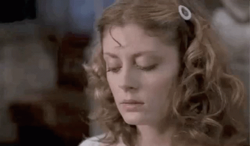 Woman With Curly Hair and Hair Clip Looking Down