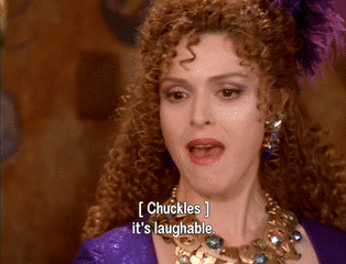 Woman With Curly Hair And Necklace Chuckles It's Laughable GIF