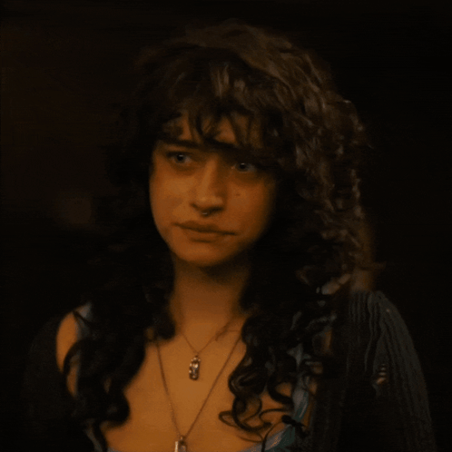 Woman With Curly Hair And Pendant Necklace GIF