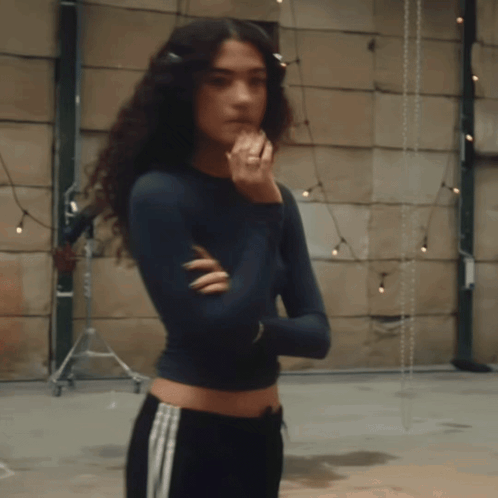 Woman With Curly Hair Arms Crossed And Ring GIF