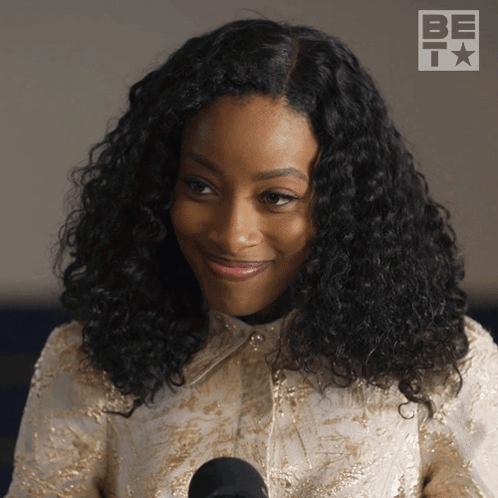 Woman with Curly Hair at Microphone