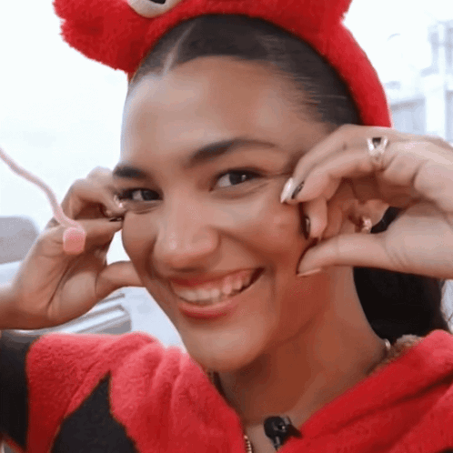 Woman With Curly Hair Drinking From Glass With Ring GIF