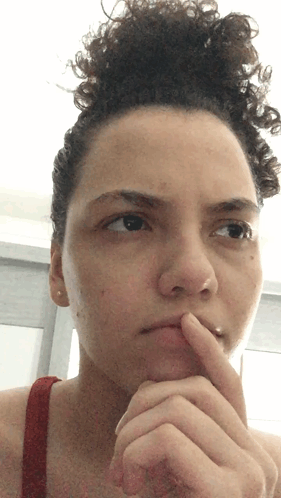 Woman With Curly Hair Finger on Chin