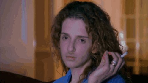 Woman with Curly Hair Holding Cigarette